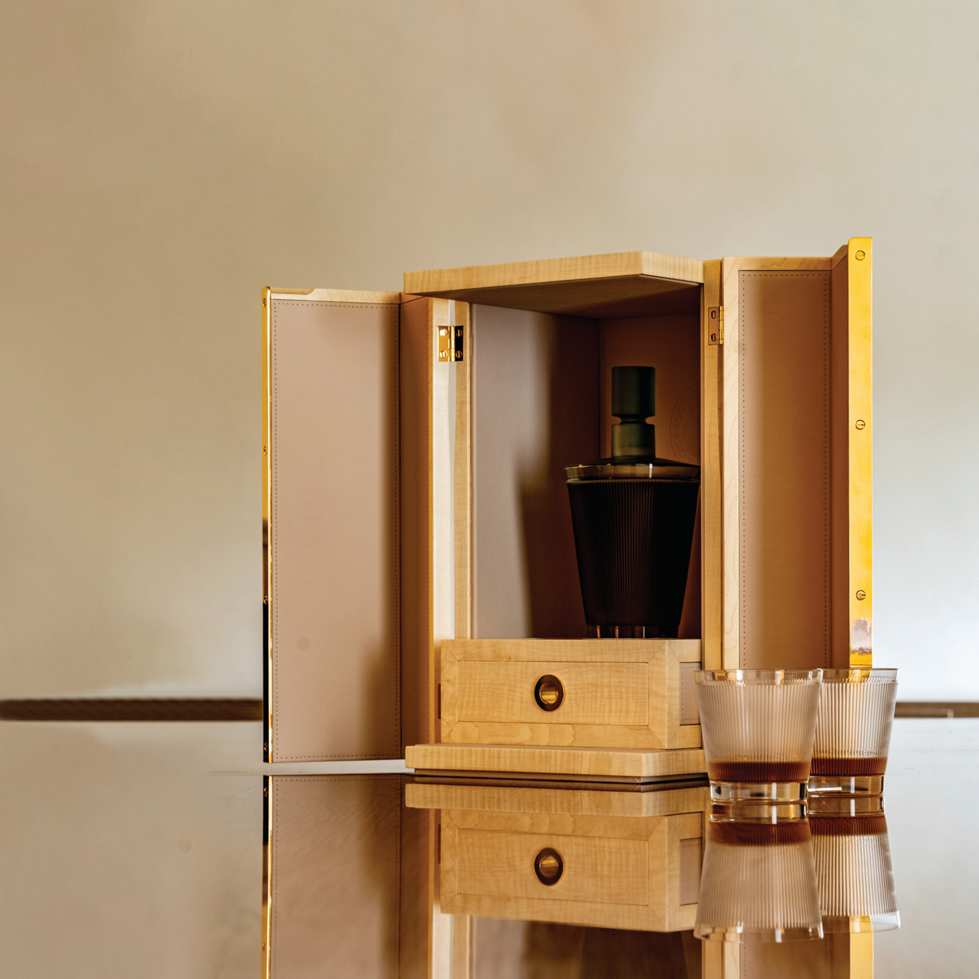 Box with alcohol bottle inside and glasses on the side