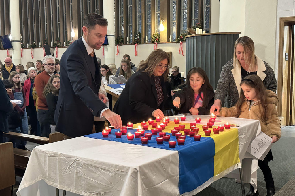 Solihull Executive Headmaster Charles Fillingham lights a candle at the Ukrainian Christmas Chapel Service.