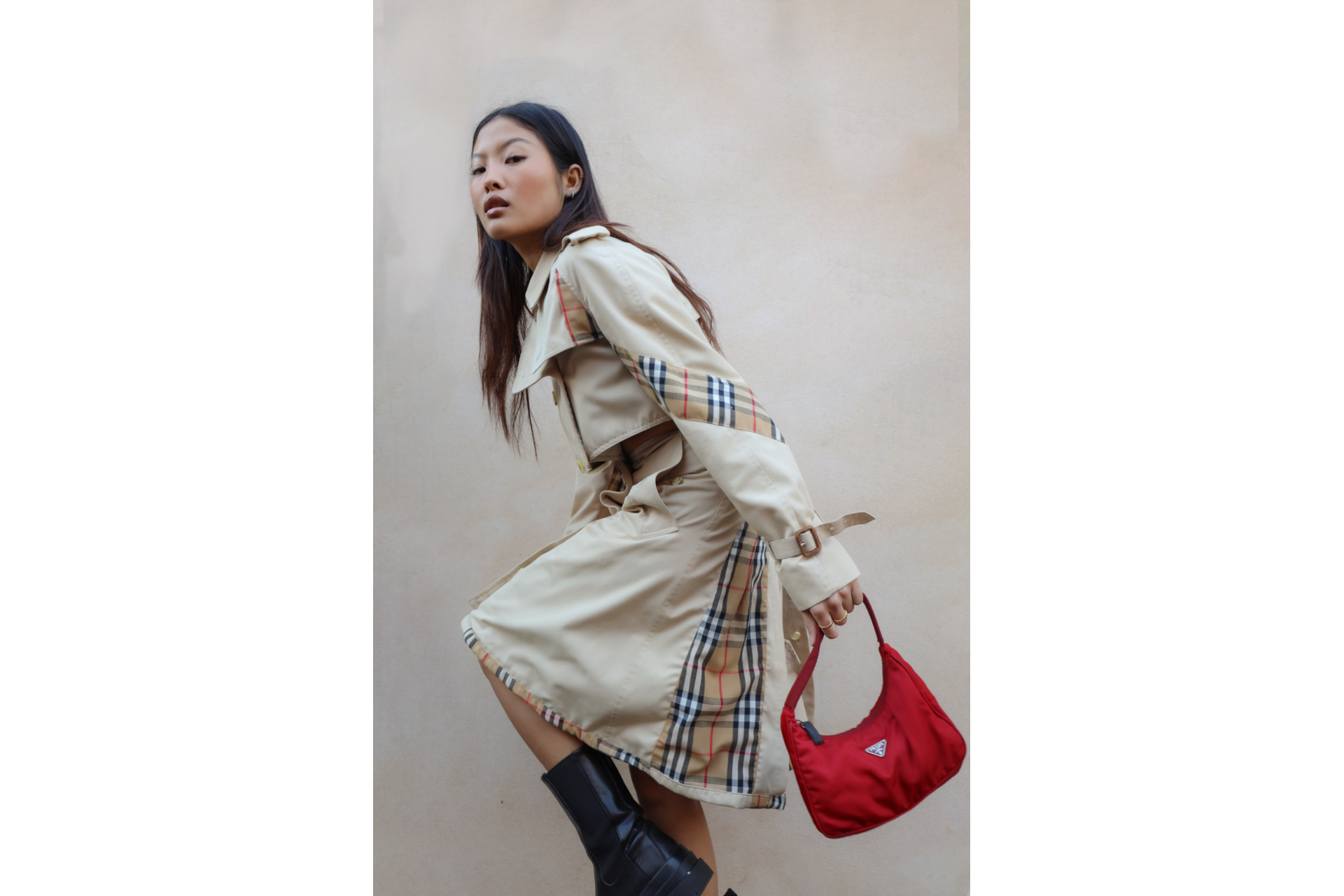 Woman in trench coat holding red bag