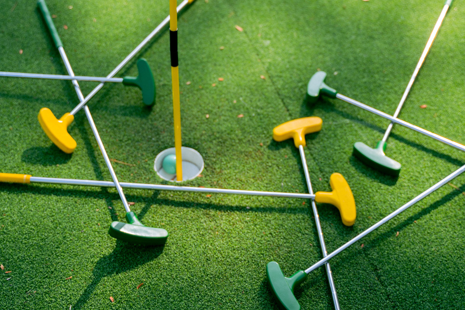 Mini golf clubs around a golf hole