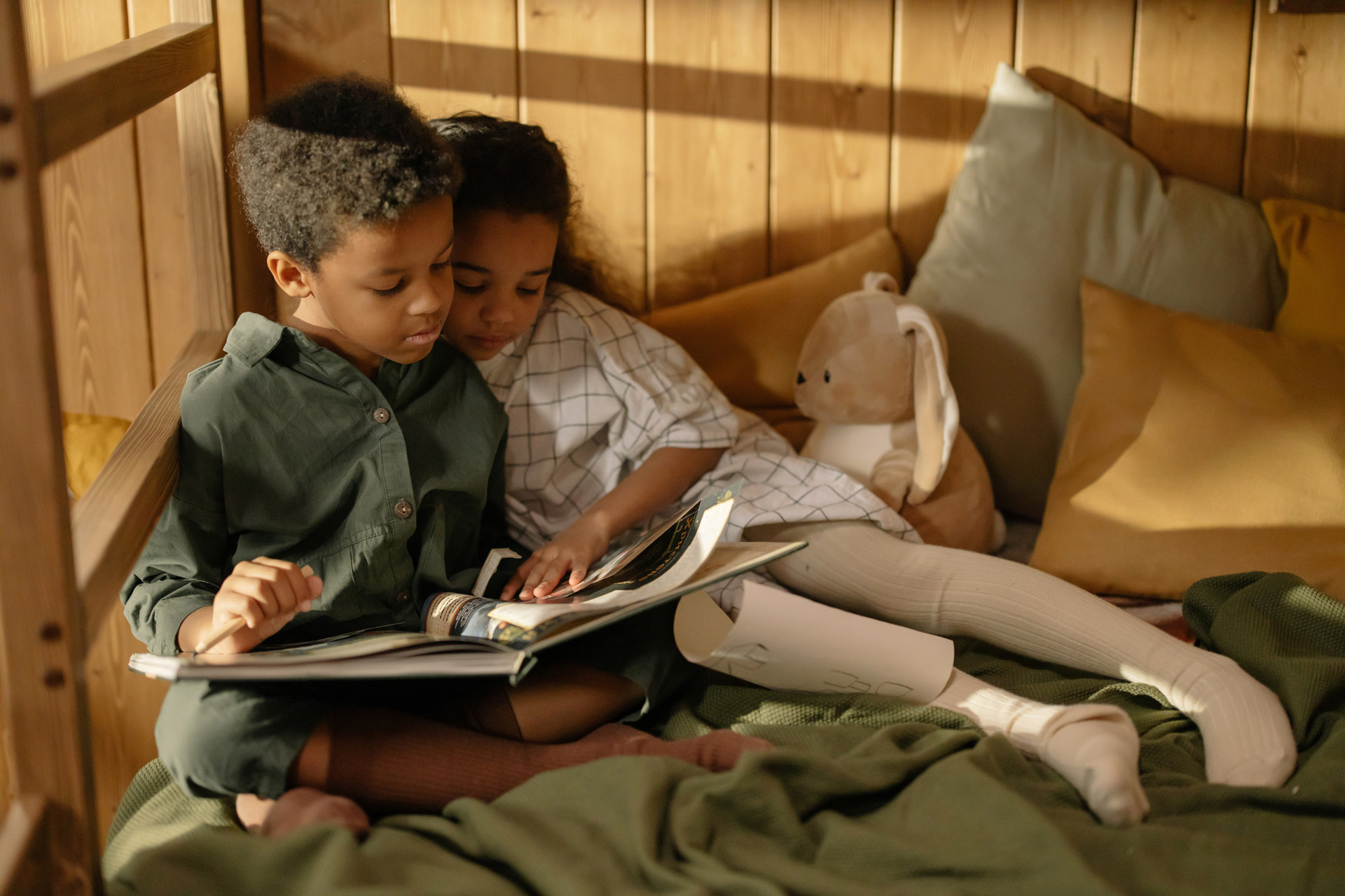 Two children reading a book about climate change together