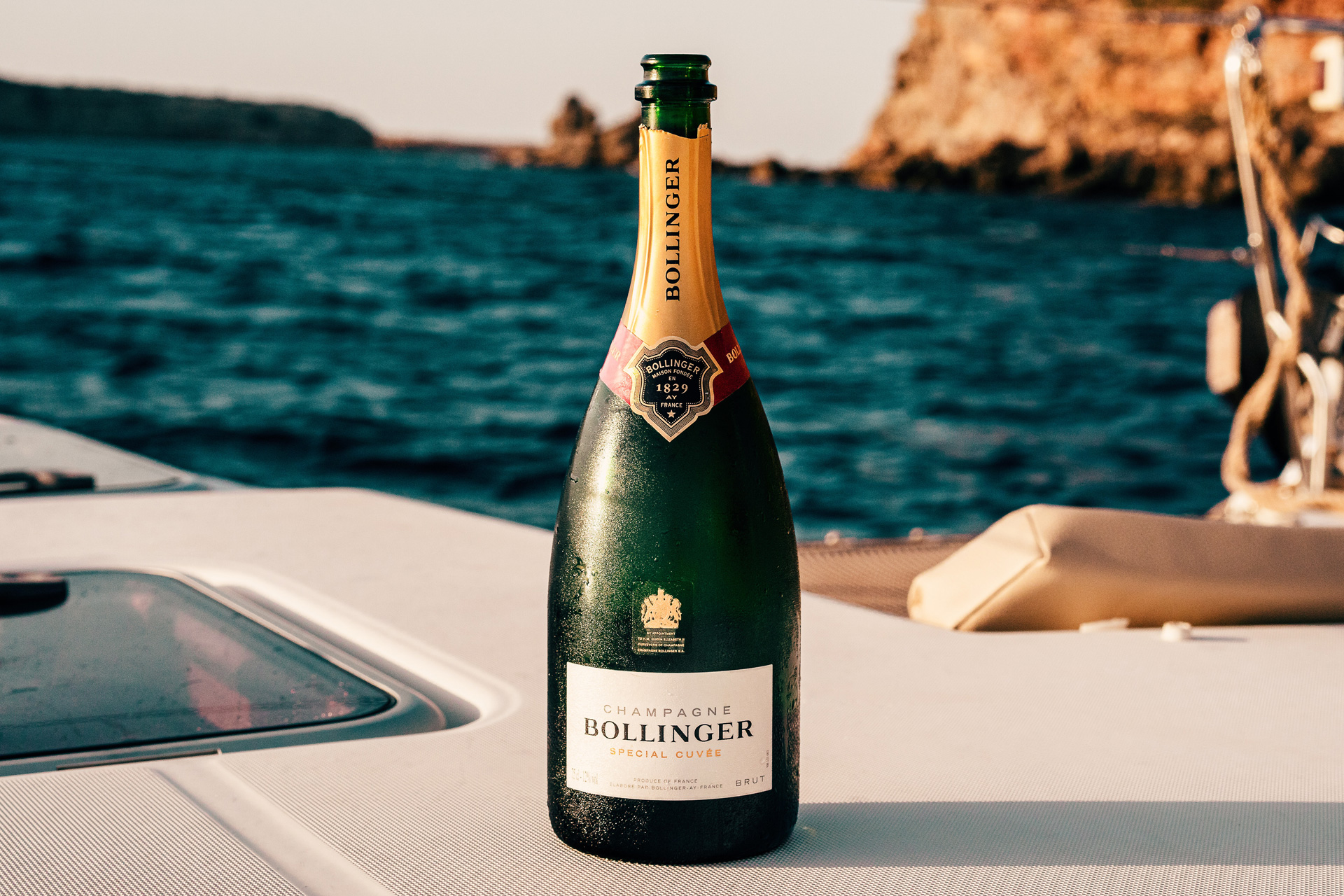 A bottle of Bollinger champagne by the sea