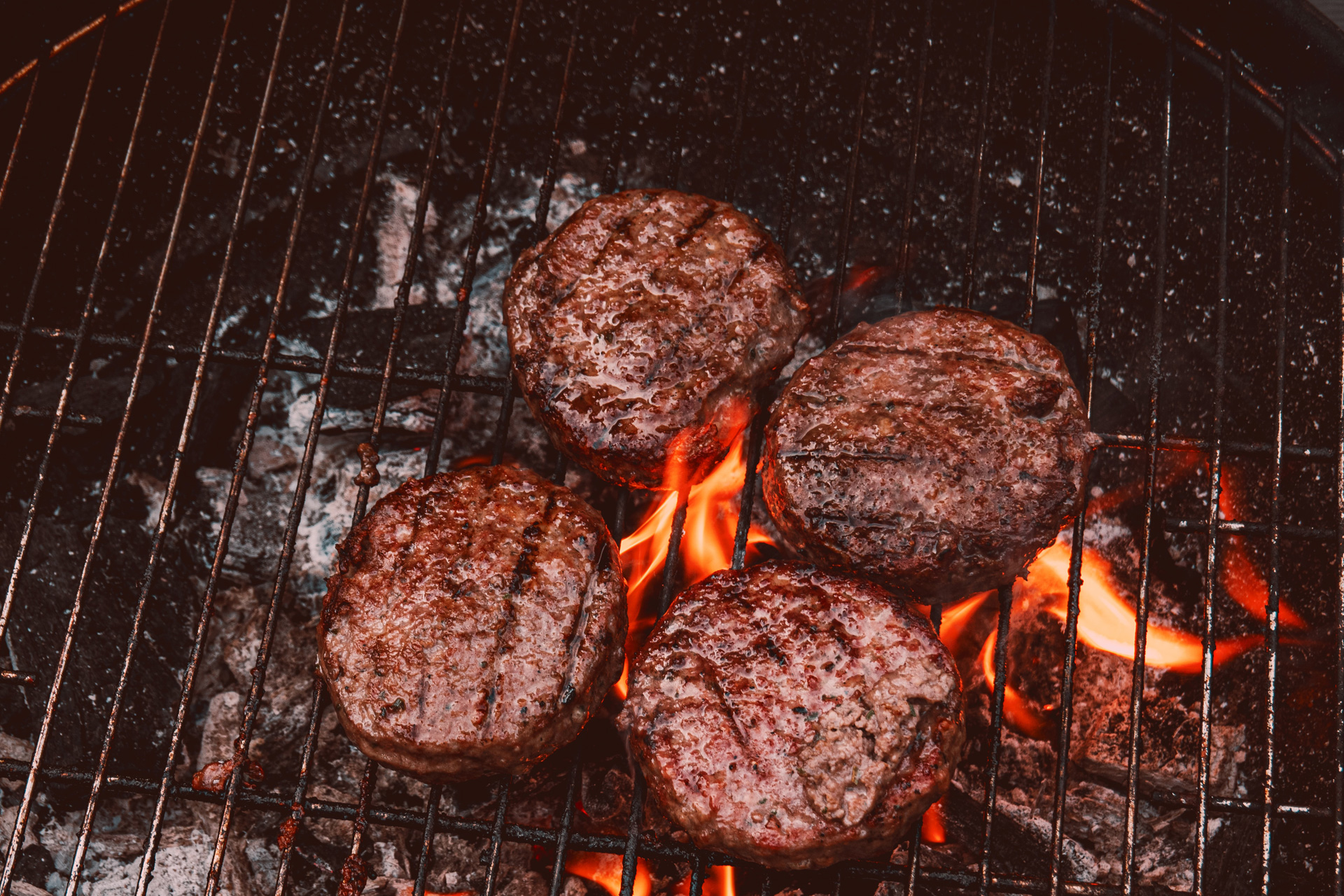 Burgers cooking on a BBQ