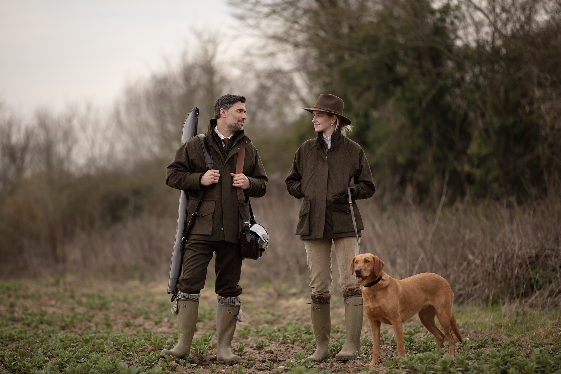 Farlows man woman and dog in field - British Sporting Brands