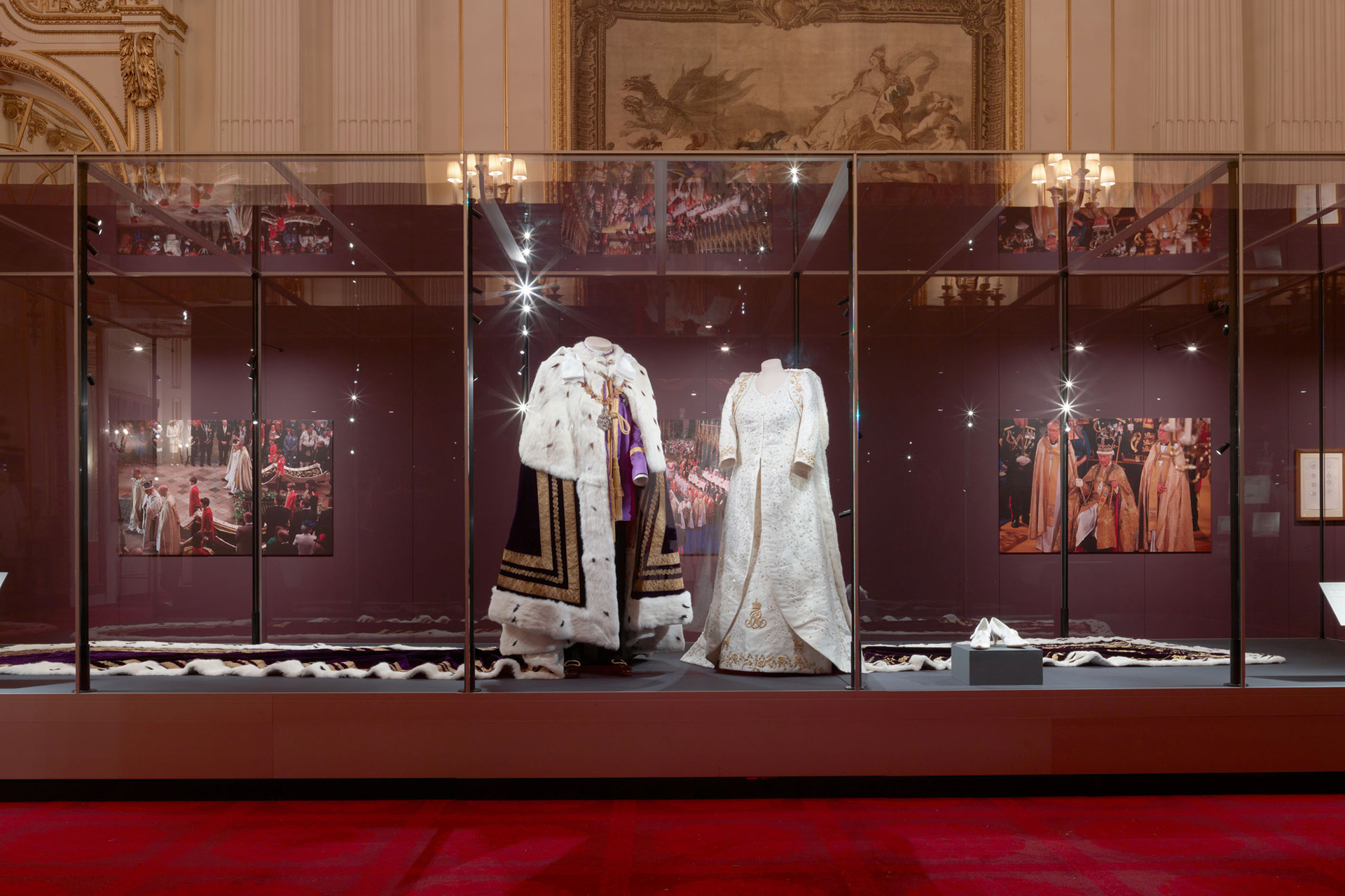 King Charles & Queen Camilla’s Coronation Outfits Are On Display At Buckingham Palace