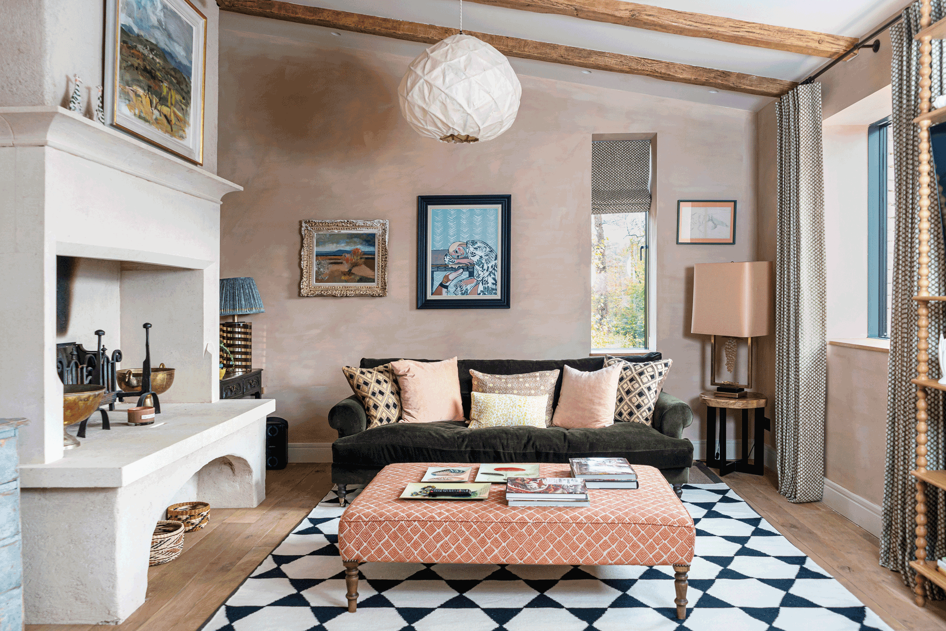 Room featuring a blue and white Amy Kent rug with light pink and charcoal grey furniture.