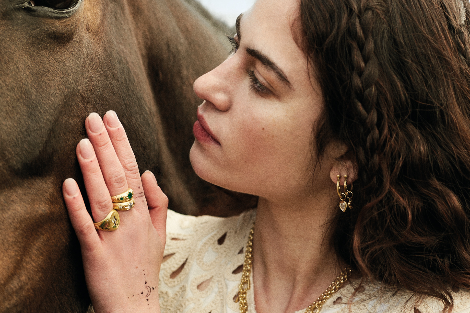 Close up of woman with hand on horse