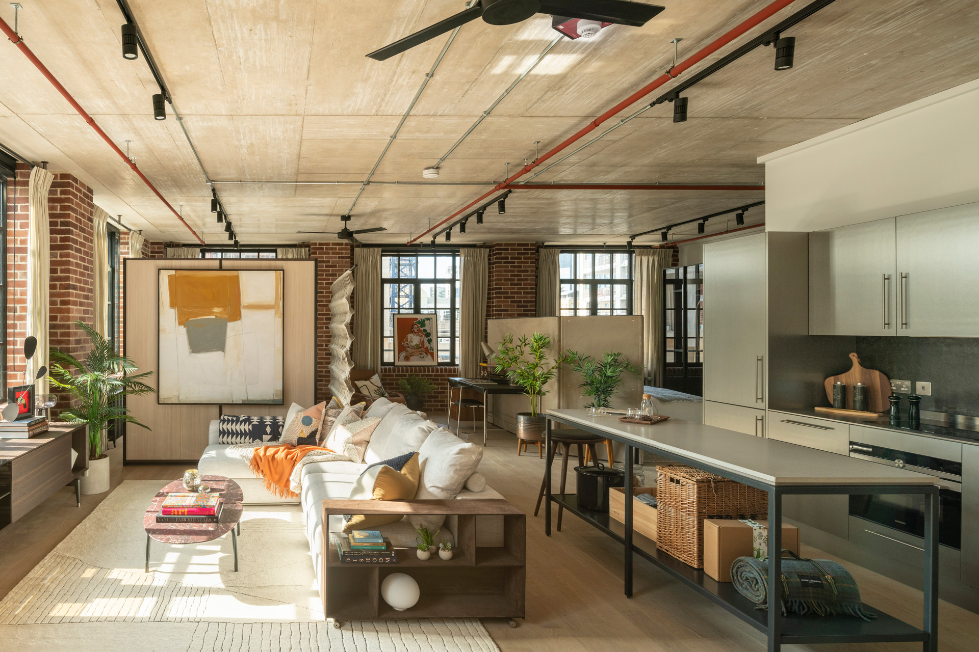 Open-plan living room and kitchen, furnished in an industrial style.