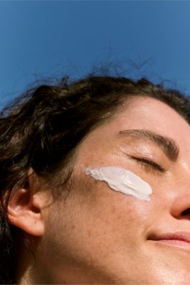 Woman with sun cream on face