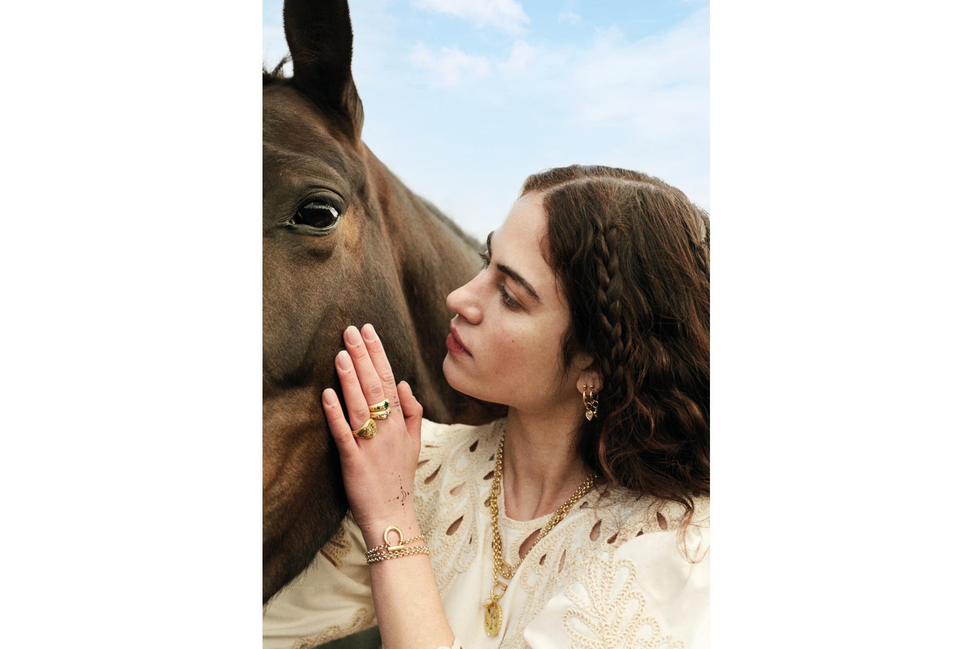 Close up of woman with hand on horse