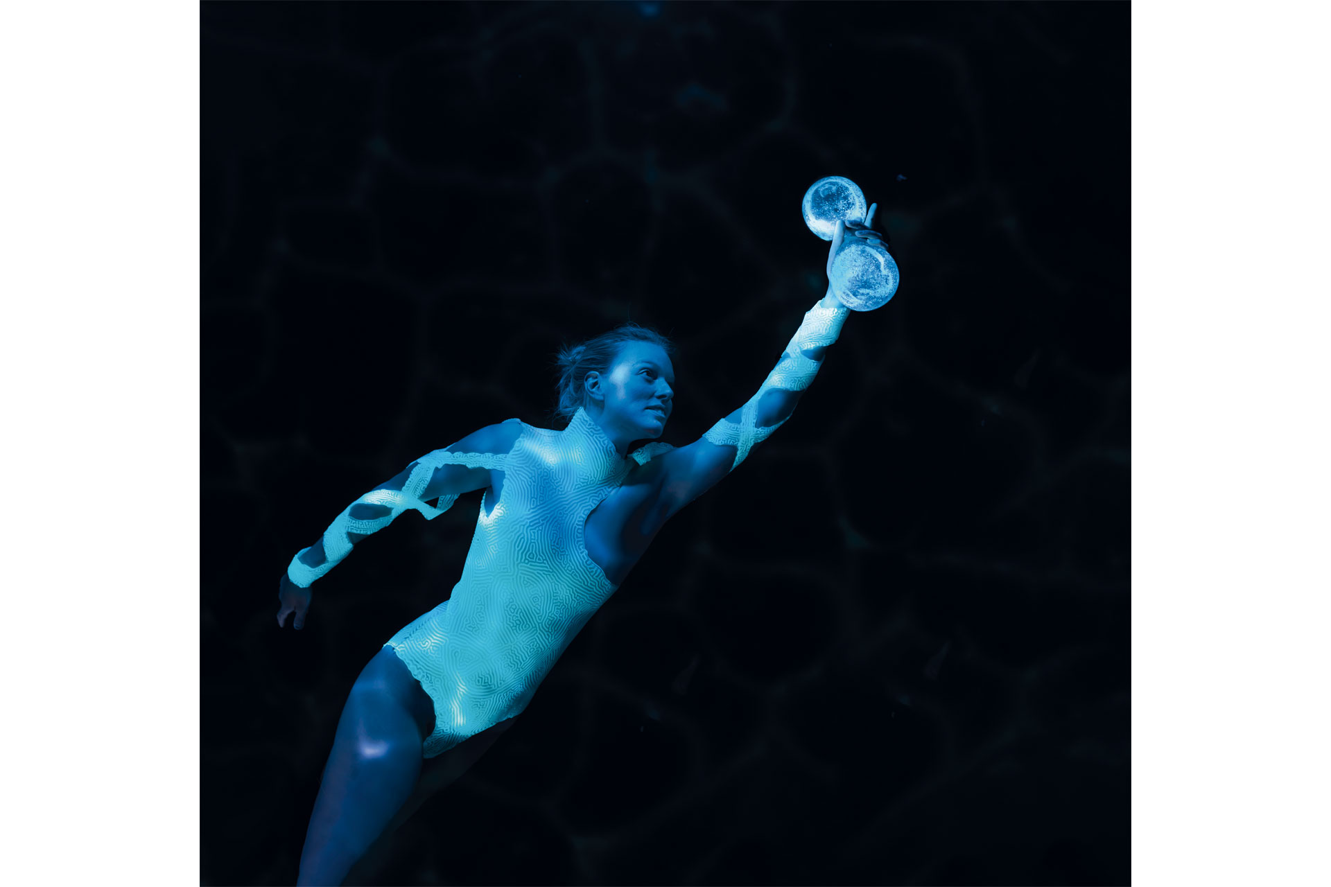 A diver holding a new technology that lights up when touched