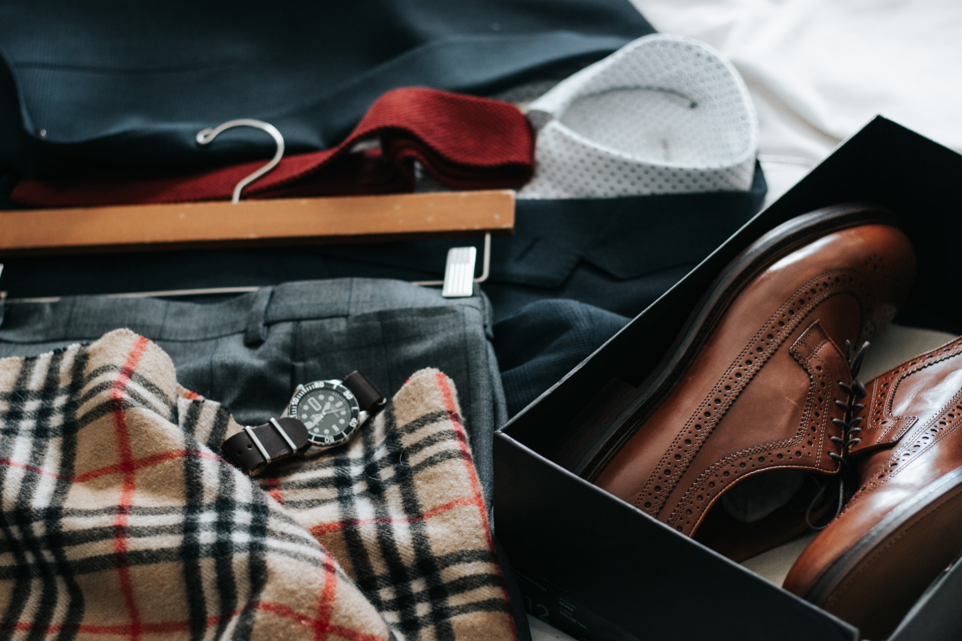 Men's formal clothes laid out on bed