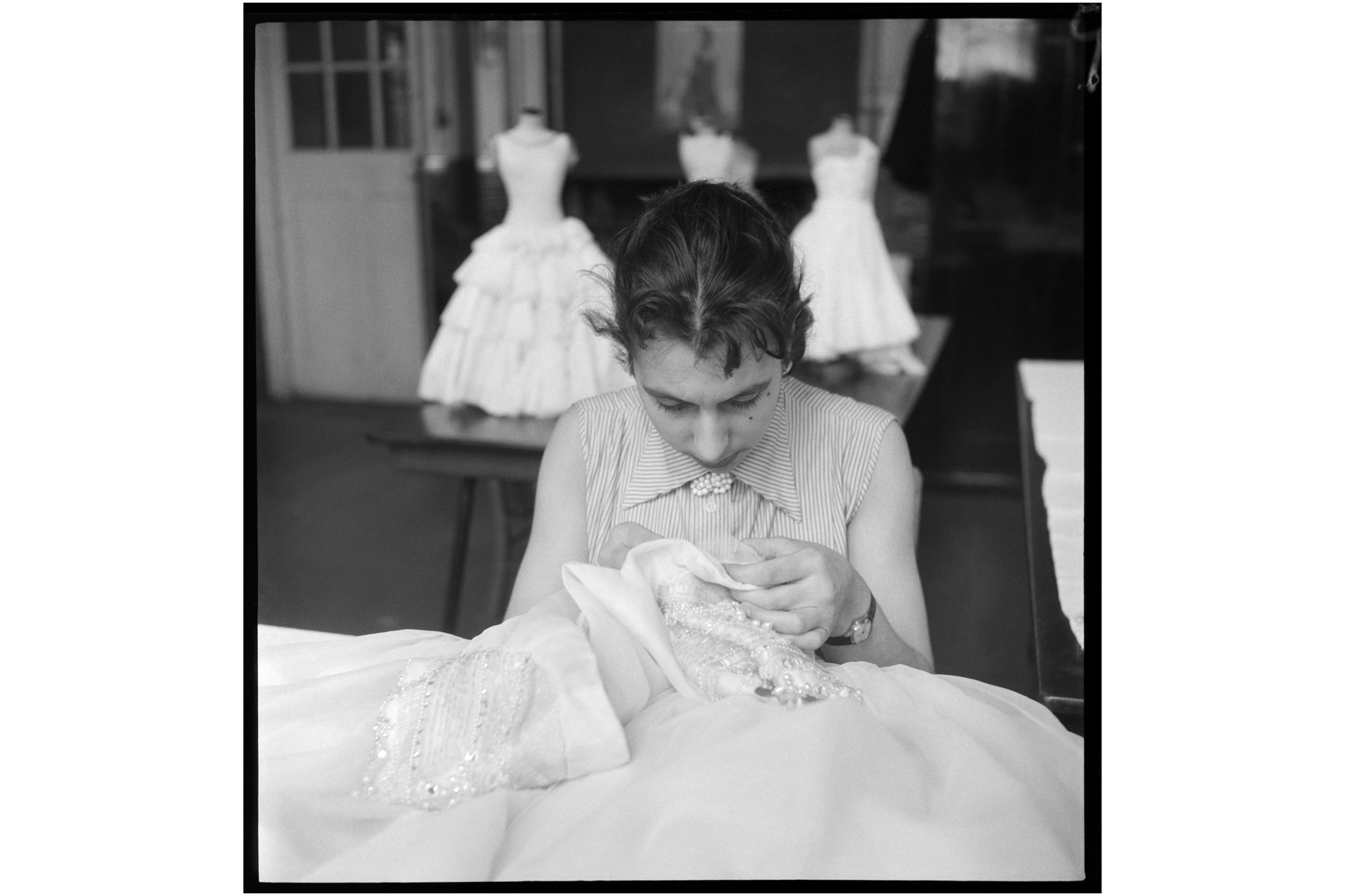 Fashion City: The image shows a dressmaking student doing hand embroidery