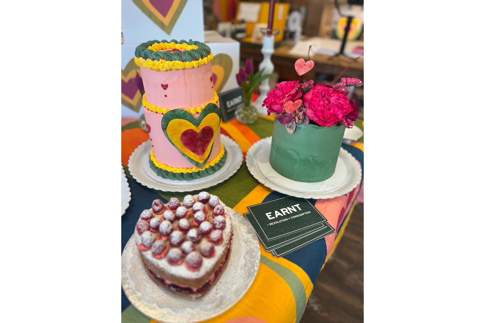 Colourful cakes set up on table with EARNT note cards