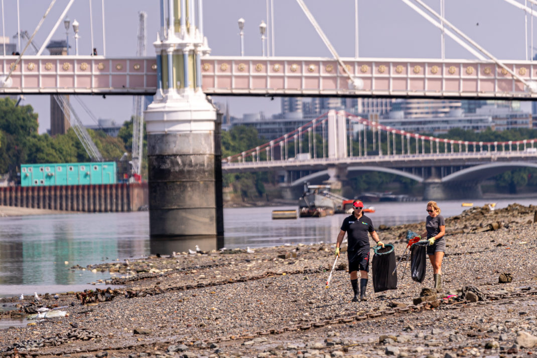 People picking up litter on the river banks of the Thames