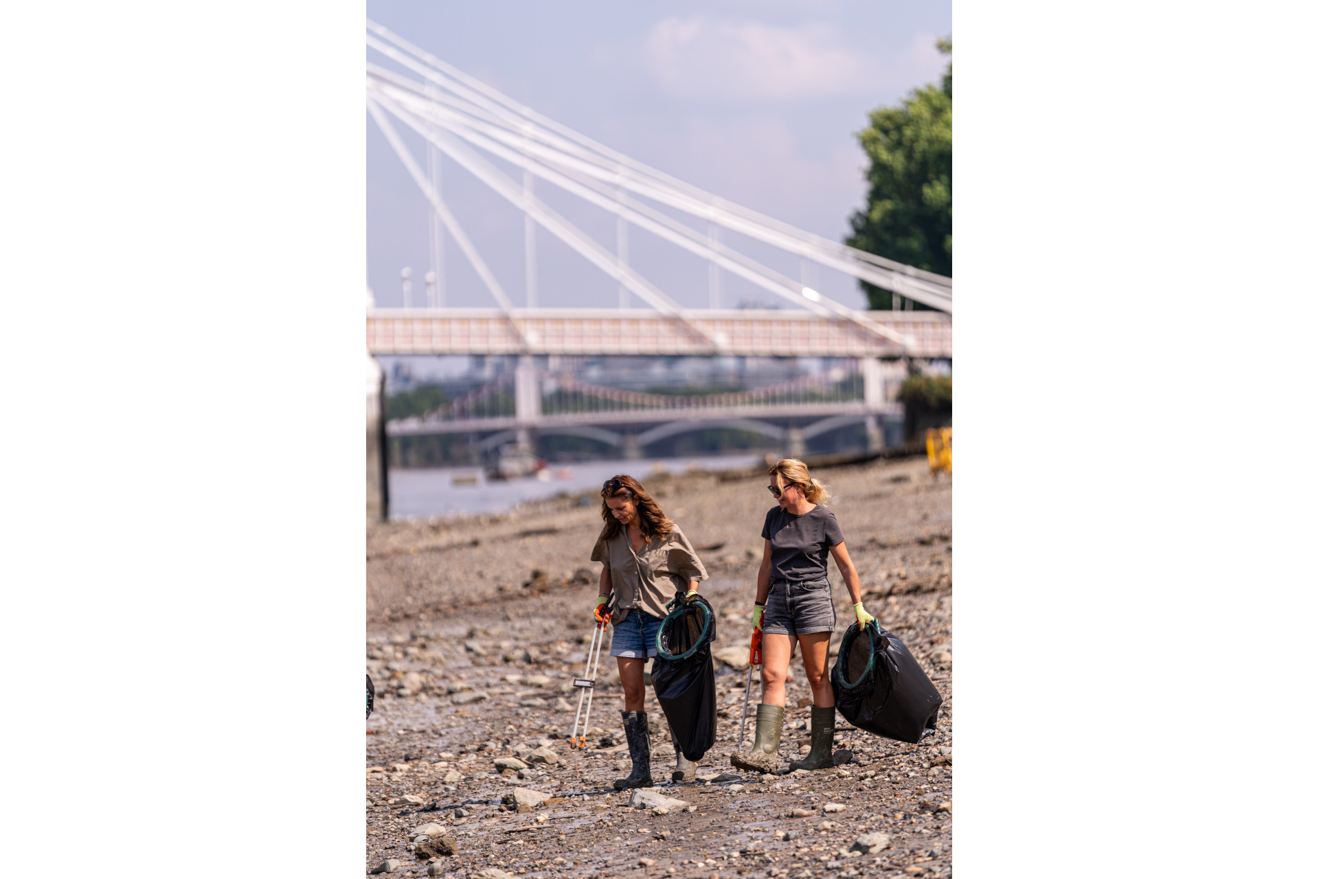 People picking up litter on the river banks of the Thames