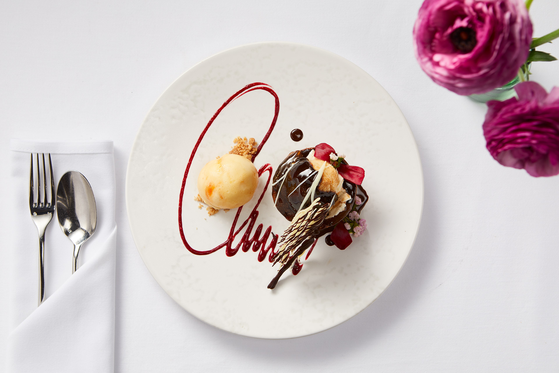 Chocolate tart with roses in a vase beside