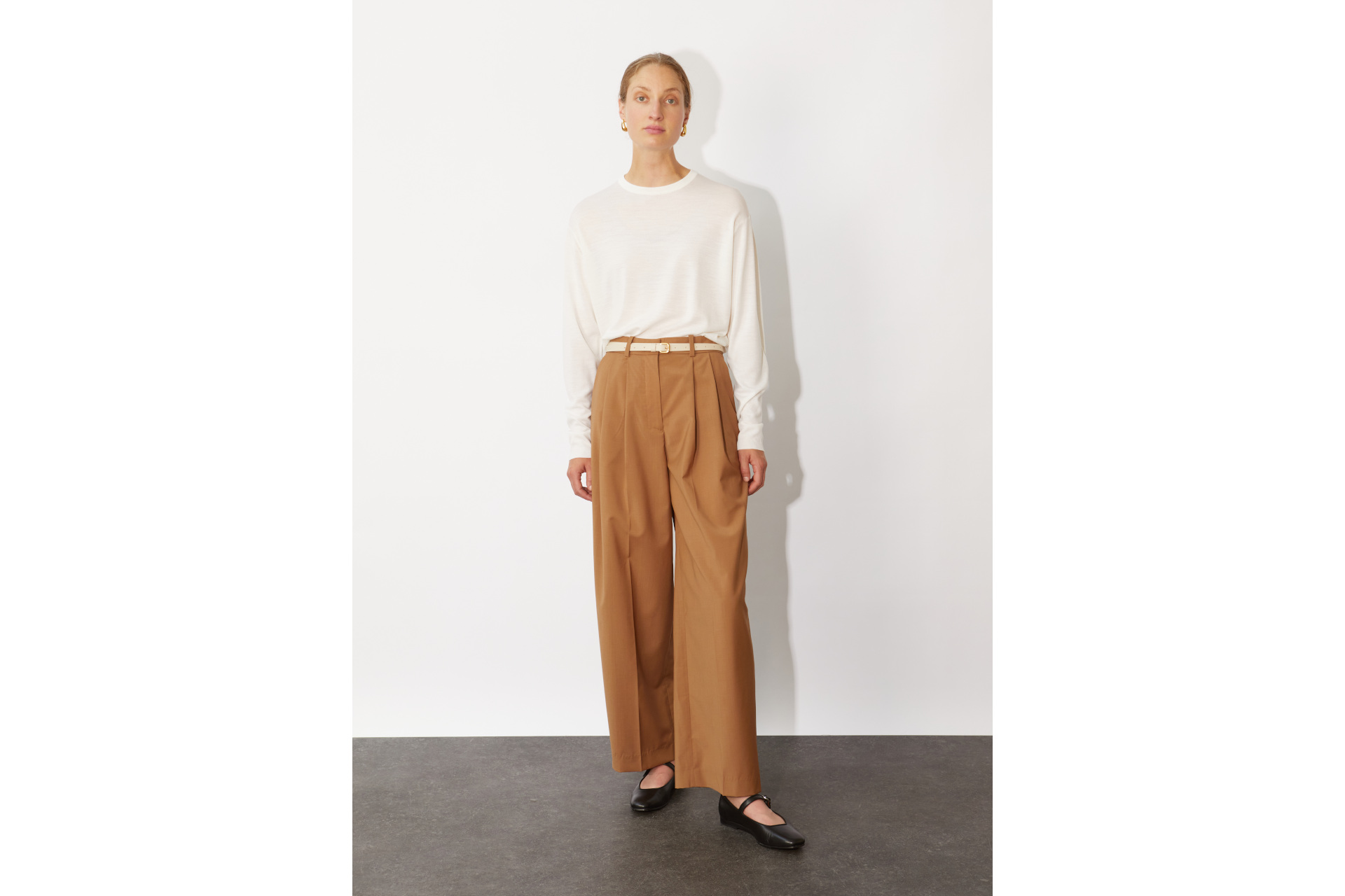 Woman in white top and brown trousers