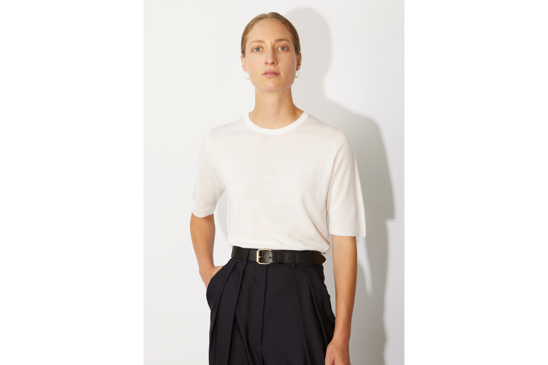 Woman in white shirt and black trousers