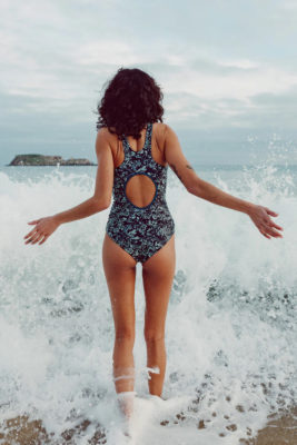 A woman walking into the sea