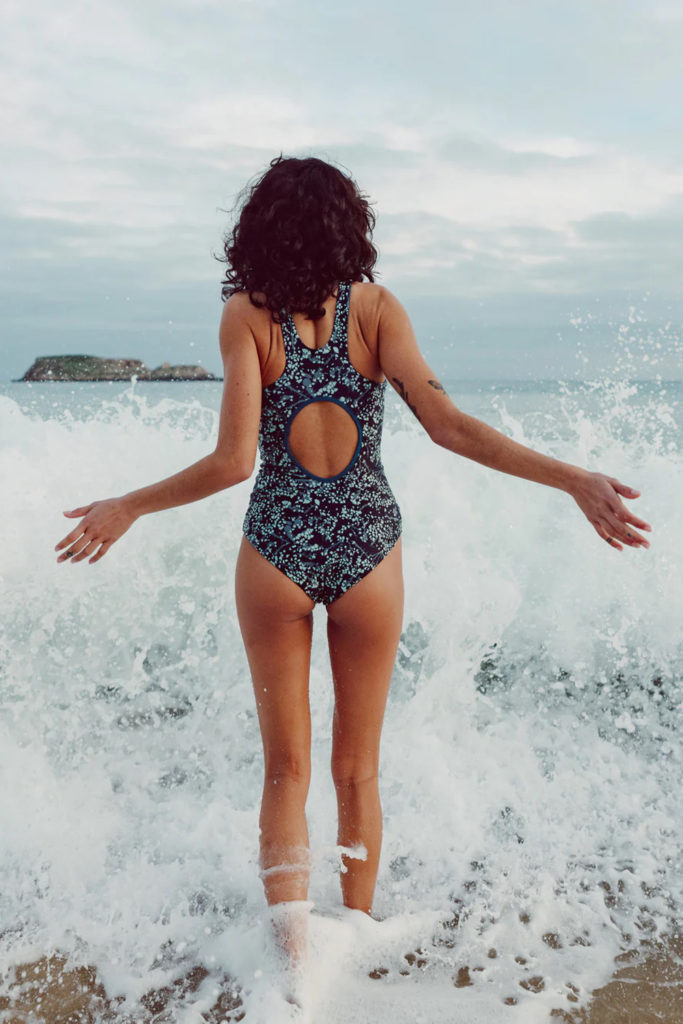 A woman walking into the sea