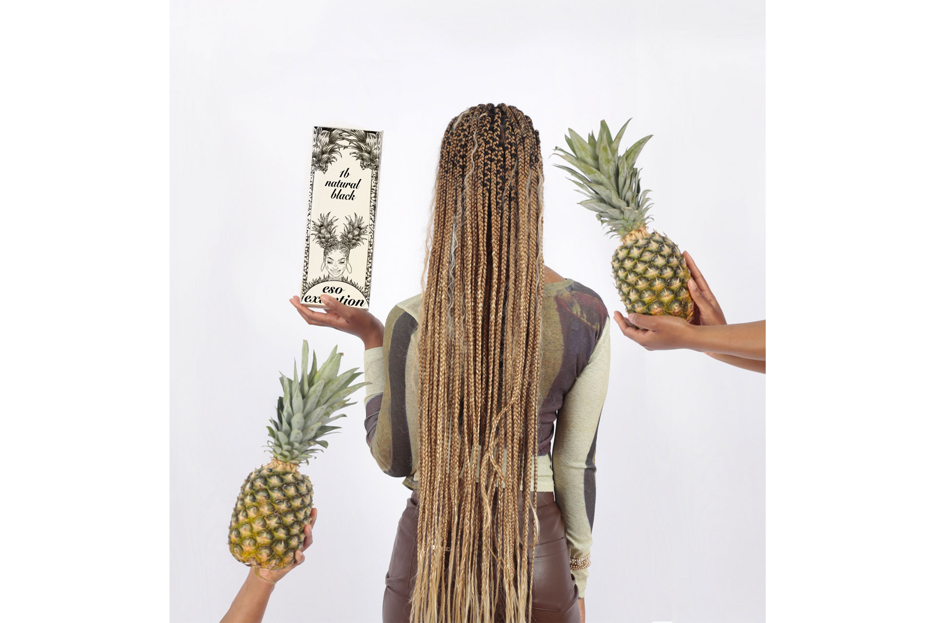 A black girl with long hair extensions with pineapples held in the images