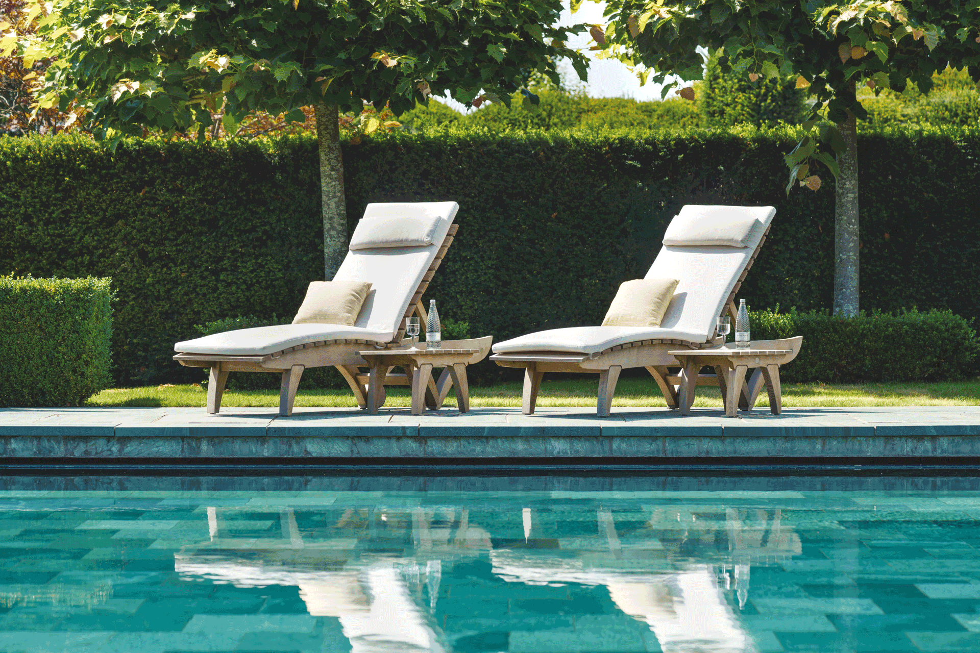 Gaze Burvill wooden sunloungers by a swimming pool