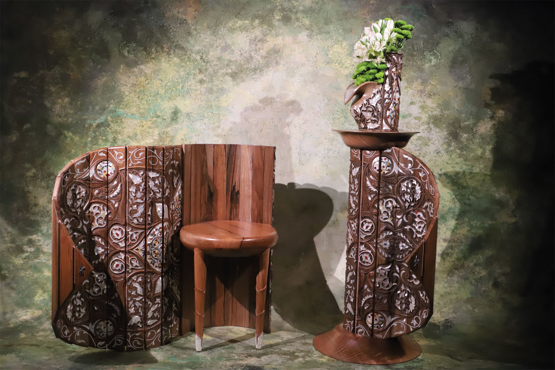 An intricate table next to a wooden stool