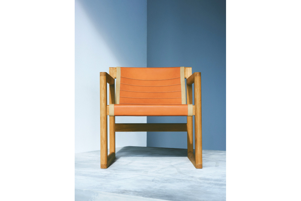 Orange chair in front of blue background