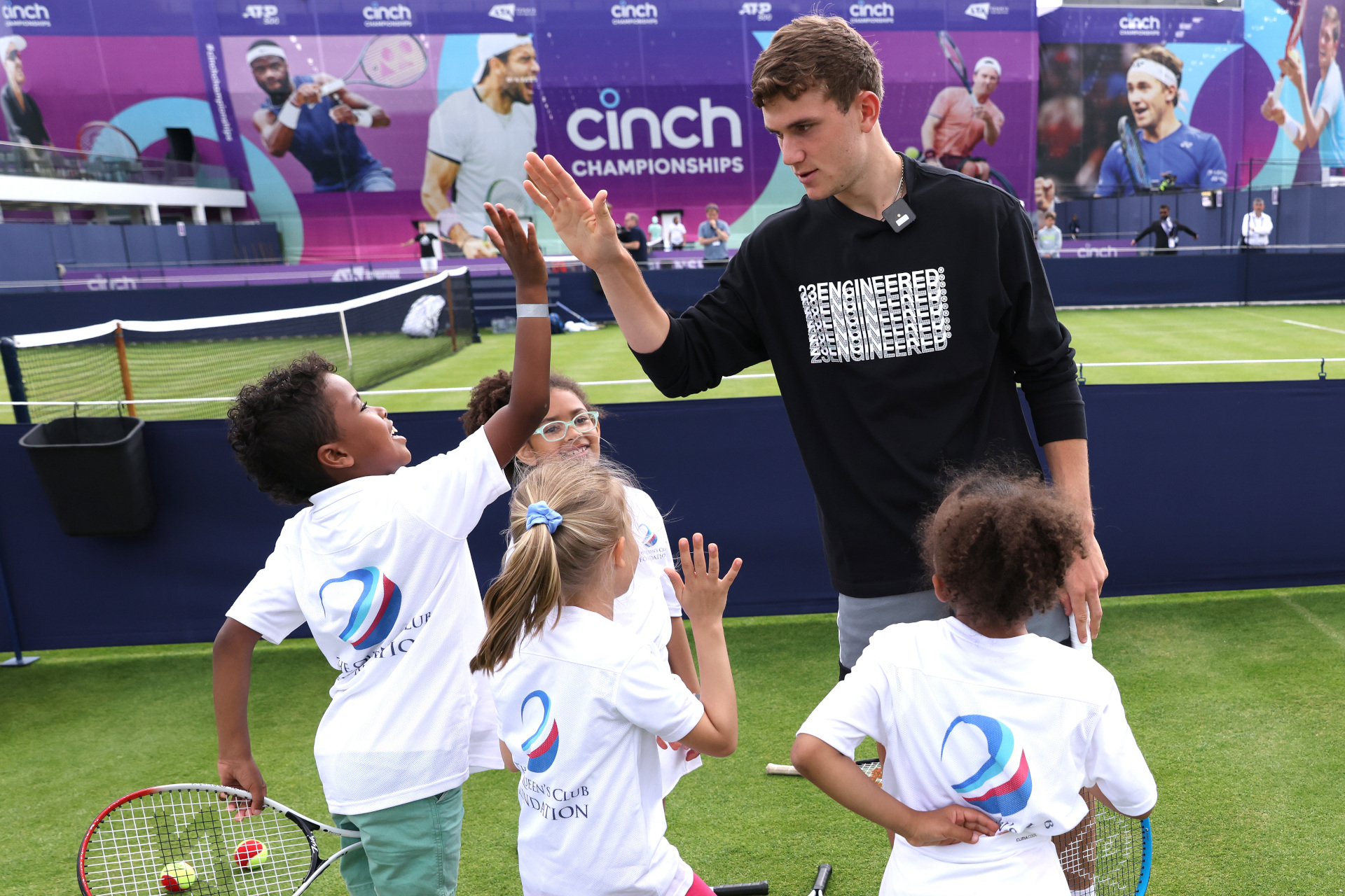 Jack Draper with children on tennis court