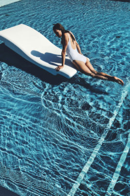 Woman sunbathing in pool