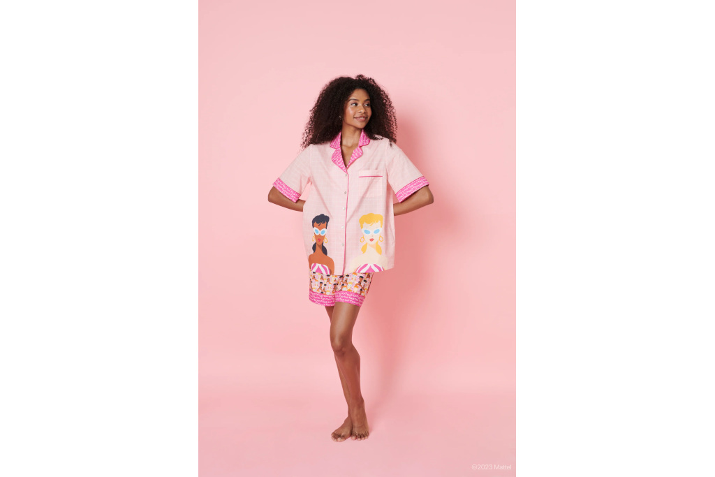 Woman in pink shirt and shorts on pink background