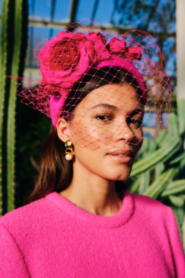 Woman in pink outfit and hat