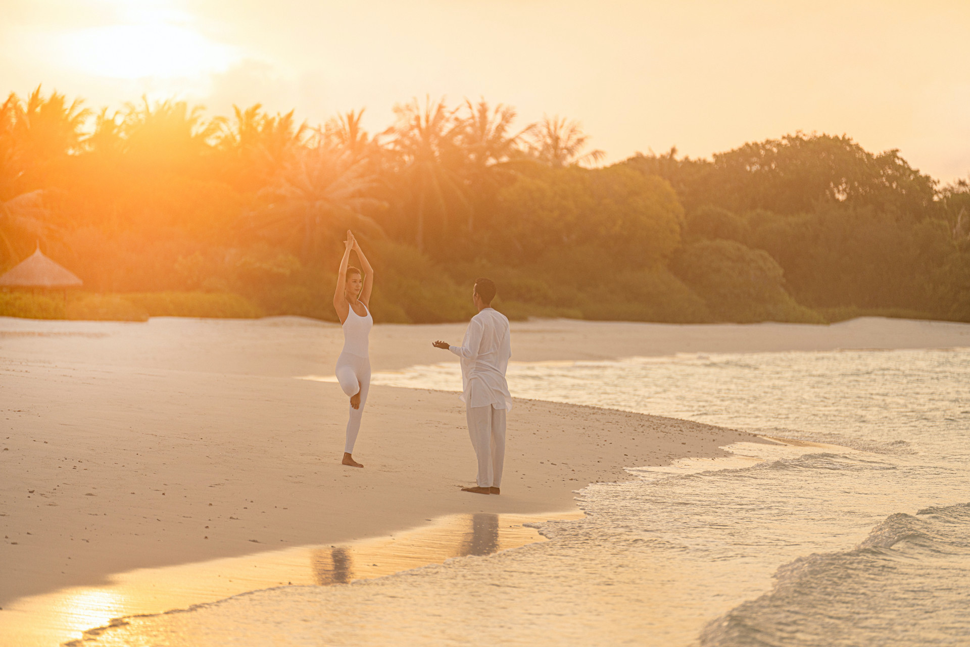 Yoga on beach at Four Seasons Landaa Giraavaru