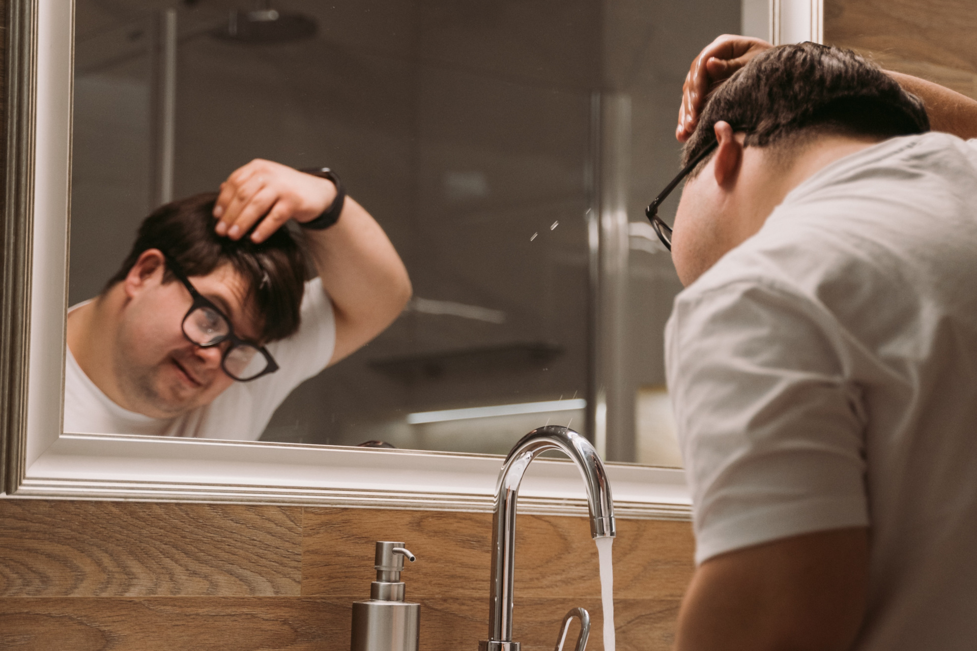 Man looking at face in mirror