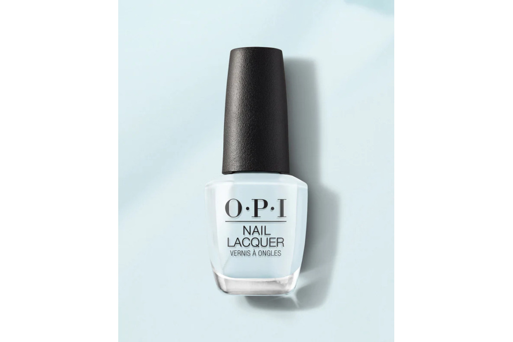 Blue nail varnish bottle on blue background