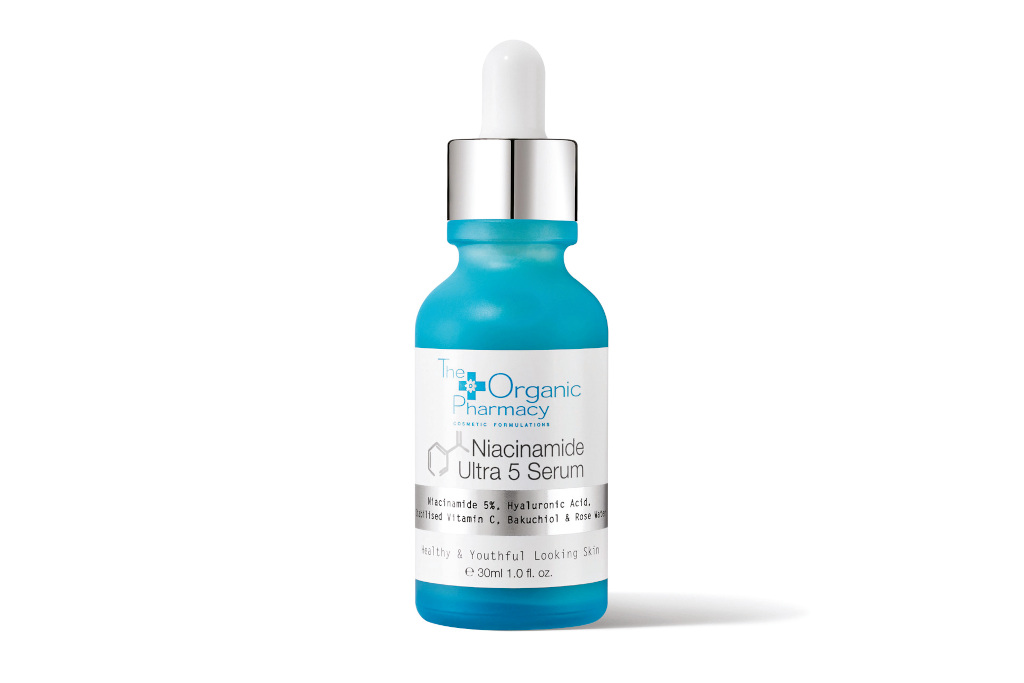 Blue serum bottle with white and silver label and stopper