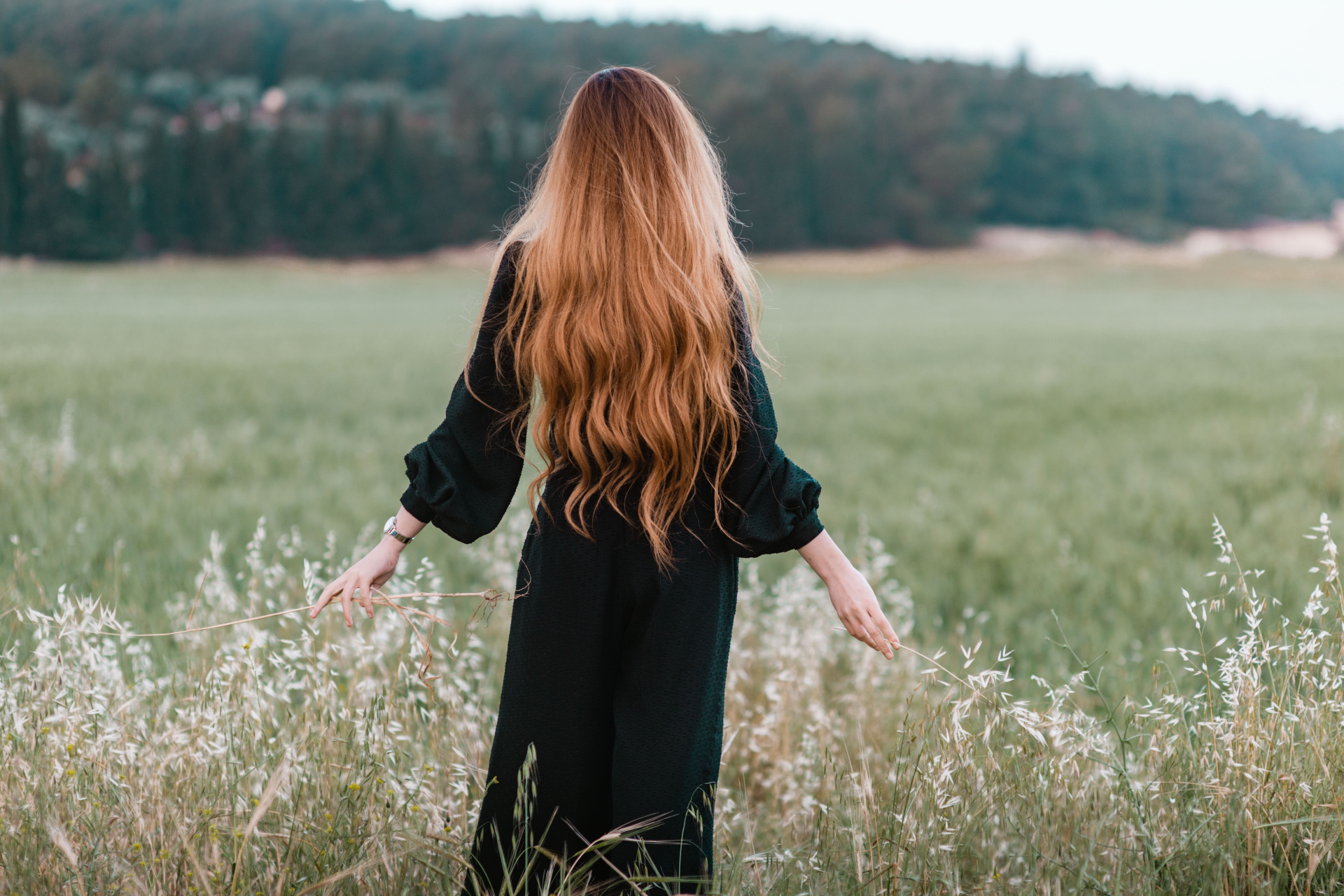 Woman with long hair in field