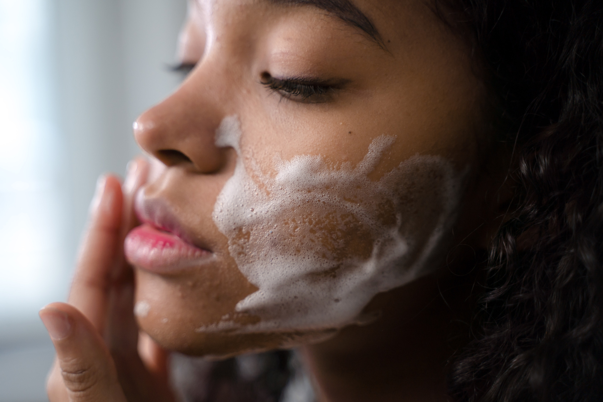 Woman applying face wash