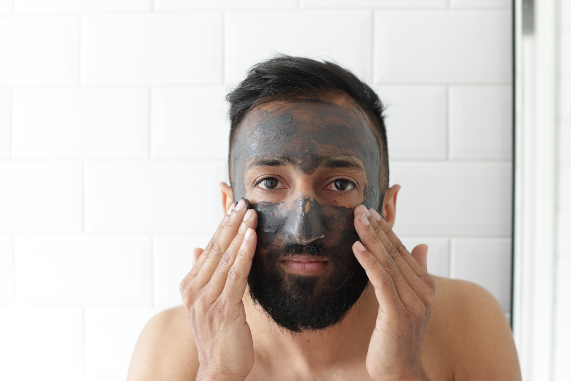 Man applying face mask cream