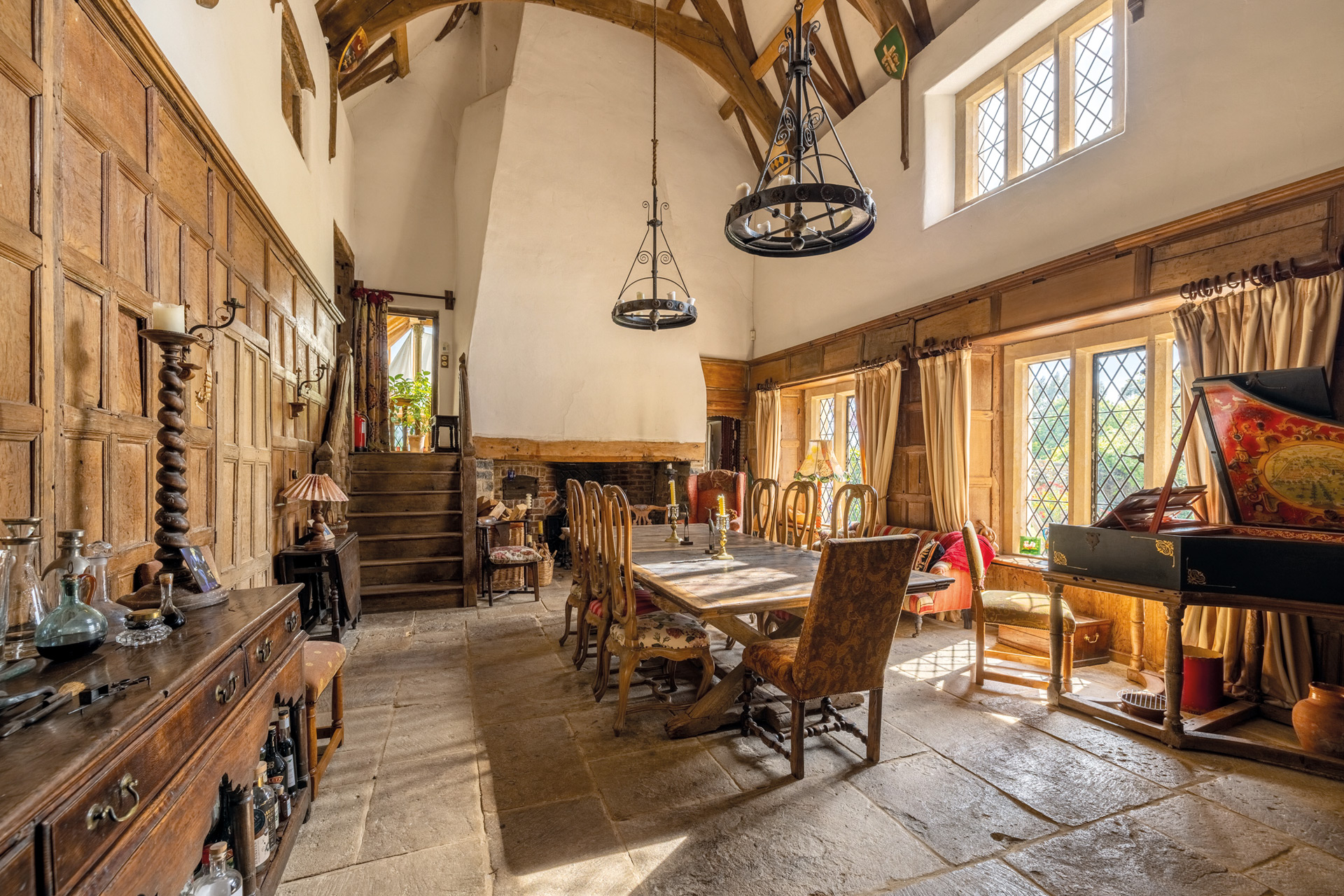 Tudor-style dining room with flagstone floors and vaulted ceiling