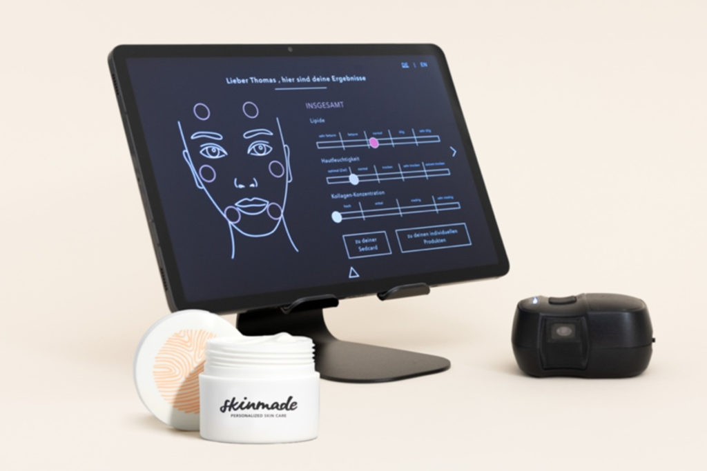Screen with face next to white pot of moisturiser