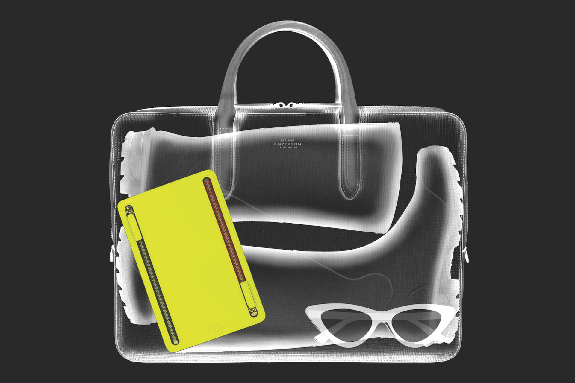 Black xray style image of bag with yellow notebook inside