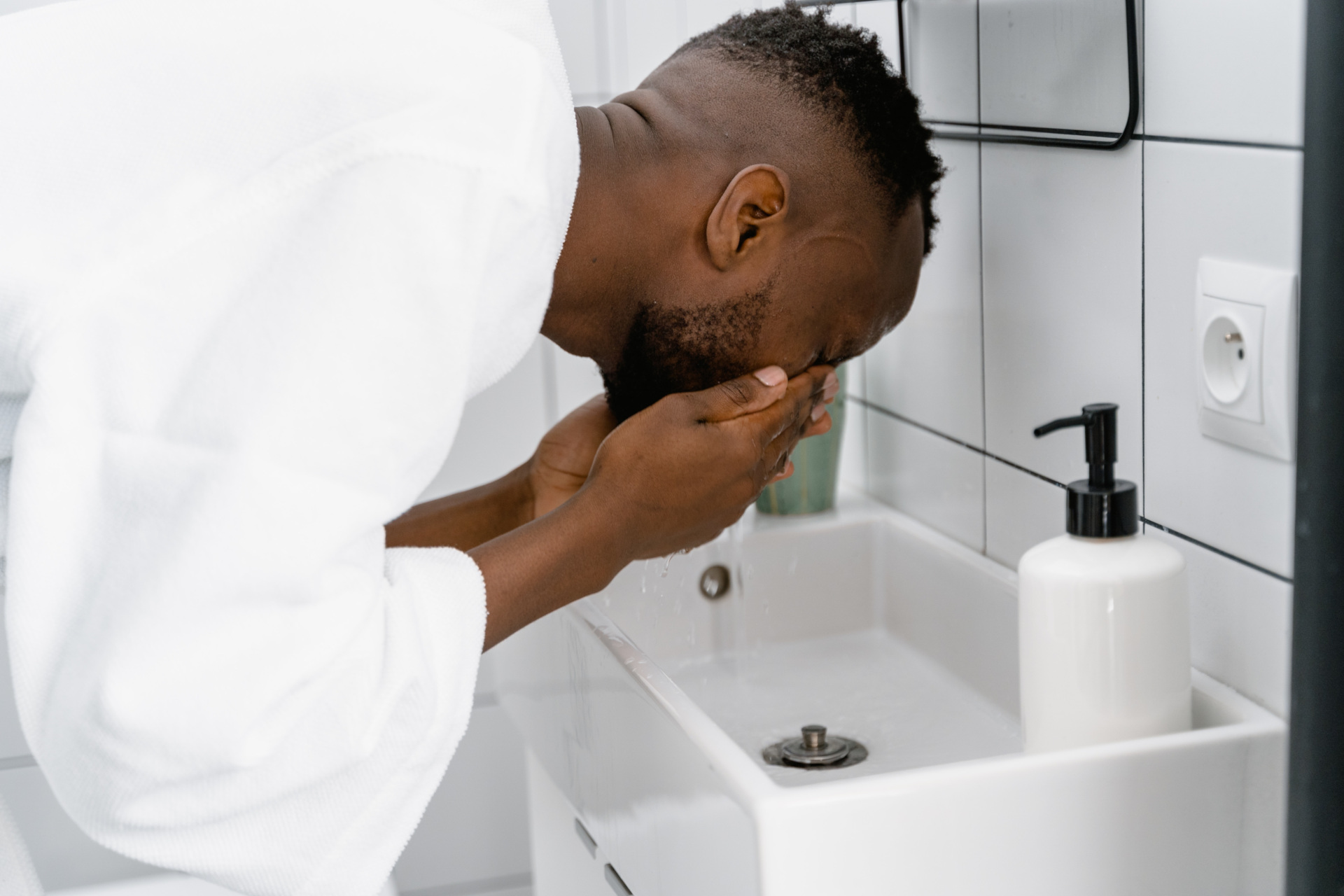 Man washing face in sink