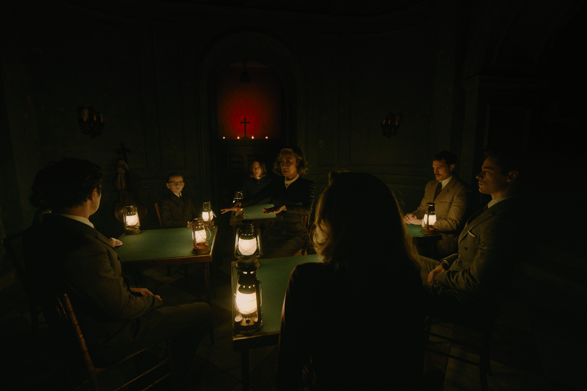 (Facing front, L-R): Jude Hill as Leopold Ferrier, Camille Cottin as Olga Seminoff, Michelle Yeoh as Mrs. Reynolds, Jamie Dornan as Dr. Leslie Ferrier, and Kyle Allen as Maxime Gerard in 20th Century Studios' A HAUNTING IN VENICE