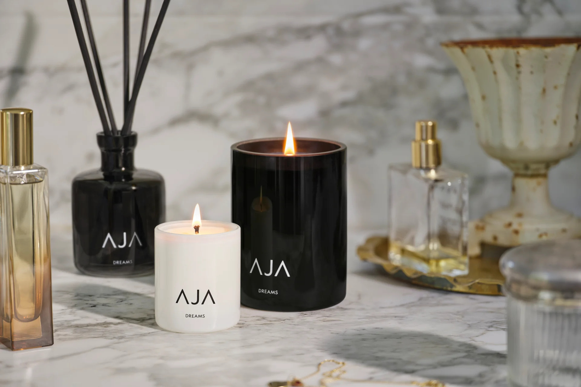 Candles and diffusers on marble backdrop