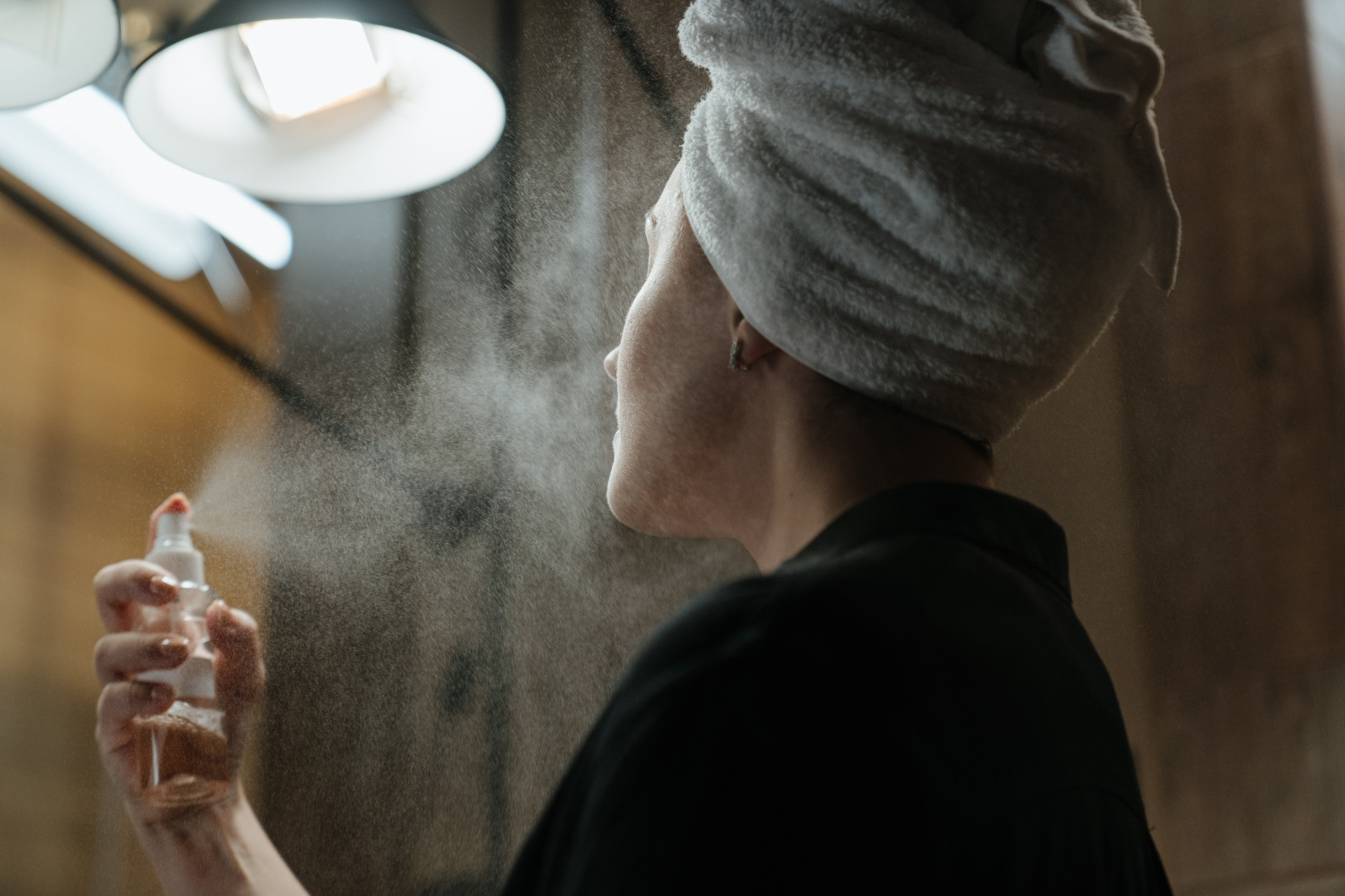 Woman spraying face