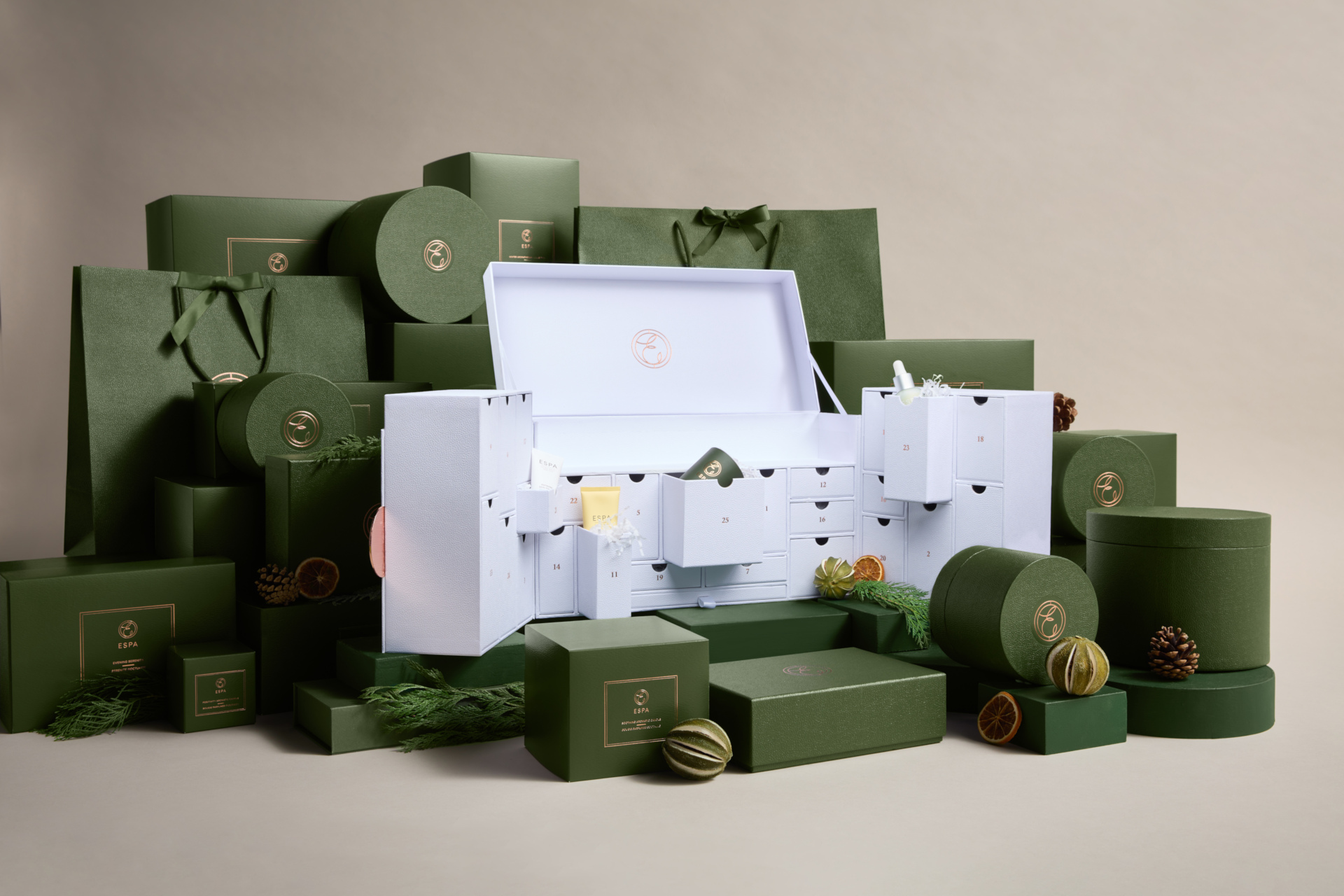 White advent calendar surrounded by green gift bags and boxes