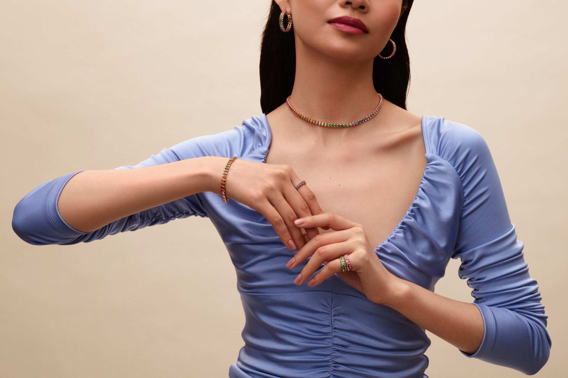 Woman in blue top and colourful jewellery