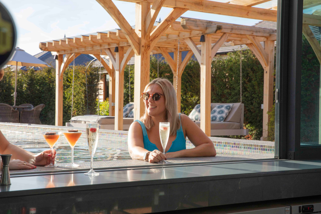 Woman at swim-up bar at Manor House Hotel & Spa, Alsager
